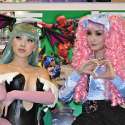 Popular Asian cosplayers Linda Le and Alodia Gosiengfiao pose for the cameras at the 2010 San Diego Comic-Con. Linda cosplays Morrigan Aensland from the video game Darkstalkers. Alodia cosplays Miwako Sakurada from the anime series Paradise Kiss.